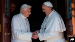 Pope emeritus Benedict XVI (l) is welcomed by Pope Francis on his return to the Vatican from the pontifical summer residence of Castel Gandolf, May 2, 2013.