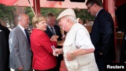 German Chancellor Angela Merkel visits a market in Greifswald, Germany, Aug. 30, 2016.