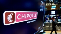 FILE - The logo for Chipotle appears above a trading post on the floor of the New York Stock Exchange.