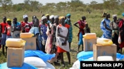 People wait in line for food at a World Food Program distribution in Jiech, Ayod County, South Sudan. (Sam Mednick/AP)