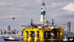 FILE - The oil drilling rig Polar Pioneer is towed toward a dock in Elliott Bay in Seattle, May 14, 2015. The rig was the first of two drilling rigs Royal Dutch Shell was outfitting for Arctic oil exploration. President Barack Obama has designated the bulk of U.S.-owned waters in the Arctic Ocean and certain areas in the Atlantic Ocean as indefinitely off limits to future oil and gas leasing.