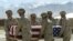 FILE - American soldiers carry the coffin of an American soldier in Afghanistan, April 26, 2003.