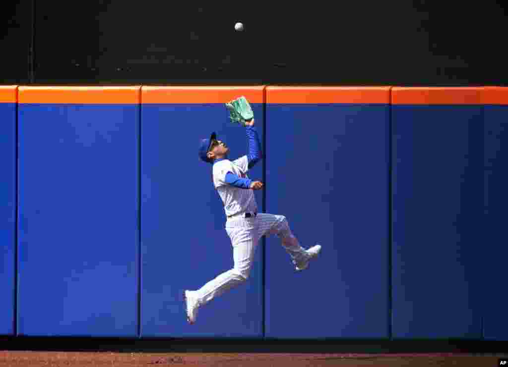 New York Mets center fielder Albert Almora Jr. makes a leaping catch during the sixth inning of a baseball game against the Washington Nationals at Citi Field, April 25, 2021, in New York.