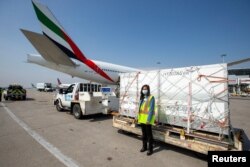 Canada's Procurement minister Anita Anand poses for a photo in front of a shipment from South Africa of the Johnson & Johnson vaccine against the coronavirus disease (COVID-19) at Toronto Pearson Airport in Ontario, Canada, April 28, 2021.