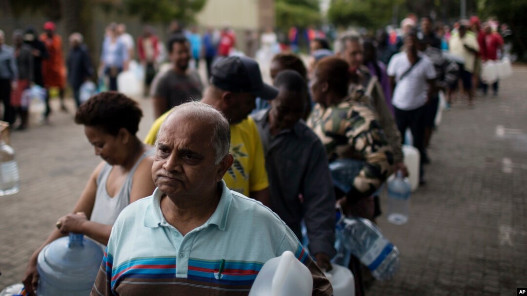 Residents line up to fill containers with water from a natural spring in Cape Town, South Africa, Feb. 2, 2018. South Africa's drought-hit city of Cape Town introduced new water restrictions in an attempt to avoid "Day Zero," the day in mid-April when it might have to turn off most taps.