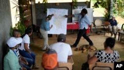 Panama Canal representatives explain to locals how a proposed dam project in the Indio River that aims to secure the canal's uninterrupted operation could affect the future of El Jobo, Aug. 31, 2024.