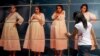 FILE - A woman adjusts cardboard boxes assembled to form a display highlighting the issue of teenage pregnancy outside the National Population Council's headquarters in Mexico City, May 29, 2014. 