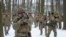 FILE - Members of Ukraine's Territorial Defense Forces, volunteer military units of the armed forces, train in a city park in Kyiv, Jan. 22, 2022.