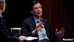 Former FBI director James Comey speaks about his book during an onstage interview with Axios Executive Editor Mike Allen at George Washington University in Washington, April 30, 2018. 