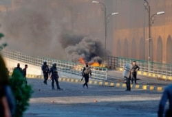 Security forces try to disperse anti-government protesters during clashes in Najaf, Iraq, Nov. 28, 2019.