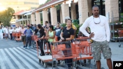 Eduardo Soriano of Miami waits in a line since dawn to purchase plywood sheets at a Home Depot store in North Miami, Florida, Sept. 6, 2017. 