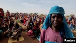 FILE: Halime Adam Moussa, a Sudanese refugee who is seeking refuge in Chad for a second time, waits with other refugees to receive a food portion from the U.N. World Food Program (WFP), near the border between Sudan and Chad in Koufroun, Chad, on May 9, 2023