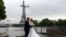 A Chinese couple have their wedding photograph taken on the flooded banks of the Seine river in front of the Eiffel Tower in Paris, France.