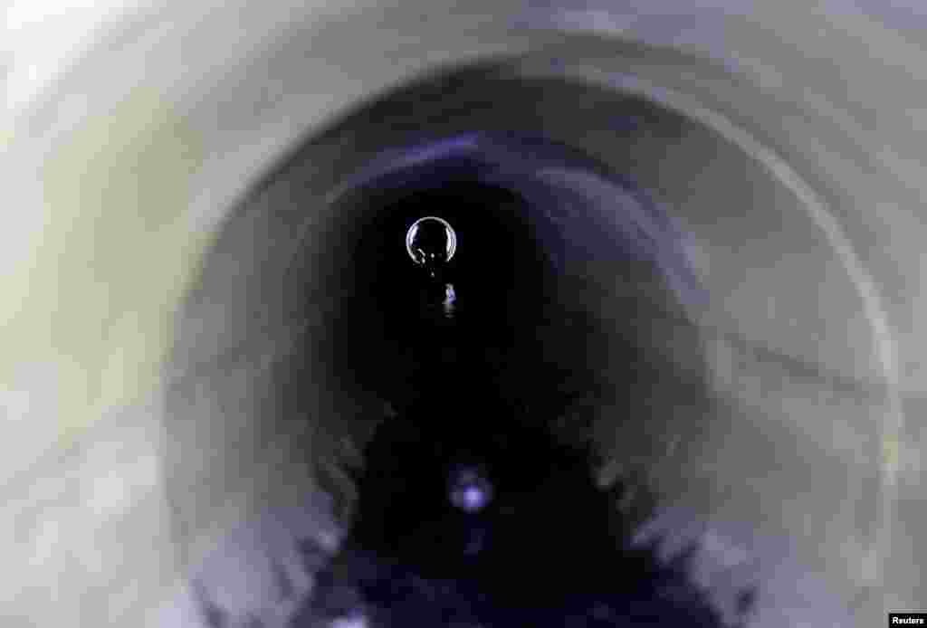 A protester tries to escape through a sewage tunnel inside the Hong Kong Polytechnic University campus.