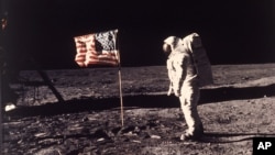 Astronaut Edwin E. "Buzz" Aldrin Jr. poses for a photograph beside the U.S. flag deployed on the moon during the Apollo 11 mission on July 20, 1969