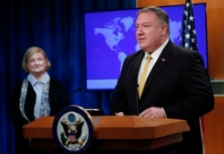 FILE - U.S. Secretary of State Mike Pompeo unveils the creation of Commission on Unalienable Rights, headed by Mary Ann Glendon, left, a Harvard Law School professor, in Washington, July 8, 2019.