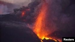 The Cumbre Vieja volcano continues to erupt on the Canary Island of La Palma, as seen from El Paso, Spain, Oct. 3, 2021. 