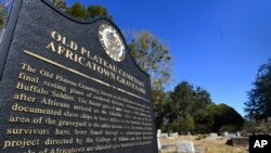 FILE - Old Plateau Cemetery, the final resting place for many who spent their lives in Africatown, stands in need of upkeep near Mobile, Ala., Jan. 29, 2019, Many of the survivors of the slave ship Clotilda's voyage are buried here among the trees.