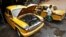 A mechanic repairs a yellow ambassador taxi at a workshop in Kolkata, May 25, 2014.