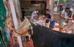 There is an Islamic rule against keeping animals near meat and knives, because it makes them to anxious for slaughter, but many butchers don’t follow it, in Cairo, July 31, 2020.