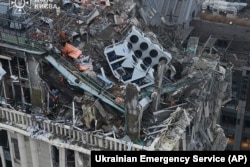 Firefighters work at the site of a damaged building after a Russian missile attack in Kyiv, Ukraine, Dec. 20, 2024. (Ukrainian Emergency Service via AP)