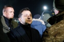 Ukraine's President Volodymyr Zelenskiy attends a ceremony to welcome Ukrainian citizens exchanged in a prisoner swap, at Boryspil International Airport, outside Kyiv, Ukraine, Dec. 29, 2019.