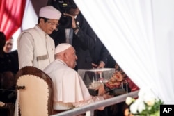 El papa Francisco recibe un modelo en miniatura de la mezquita Istiqlal mientras el gran imán de la mezquita Istiqlal, Nasaruddin Umar, observa durante una reunión interreligiosa con líderes religiosos en la mezquita Istiqlal en Yakarta, el jueves 5 de septiembre de 2024.