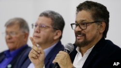 Ivan Marquez, a former leader of the Revolutionary Armed Forces of Colombia, FARC, announces that the group's onetime top commander, Rodrigo Londono, will run for president in next year's election, during a press conference in Bogota, Colombia, Nov. 1, 2017. Marquez also announced the names of other nine former rebel leaders who, with him, will fill 10 seats in Congress guaranteed to the FARC political party on a temporary basis as part of last year's peace deal.