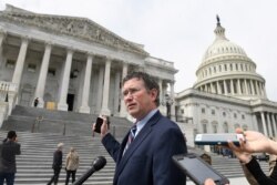 Rep. Thomas Massie, R-Ky., talks to reporters before leaving Capitol Hill in Washington, March 27, 2020, after attempting to slow action on a rescue package.