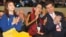 Aung San Suu Kyi (C), Olympic figure skating gold medalist Kim Yu-na (L), and Timothy Perry Shriver, chairman and CEO of the Special Olympics, at the opening of the Special Olympics World Winter Games in Pyeongchang, January 29, 2013.