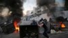 Anti-government protesters block a main highway by a garbage containers and burned tires, during ongoing protests against the Lebanese government, in Beirut, Lebanon, Nov. 4, 2019. 