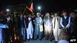 Youths and peace activists gather to celebrate the reduction in violence, in Kandahar, Feb. 21, 2020. A weeklong partial truce took hold across Afghanistan Saturday, as the war-weary country woke up to what is potentially a major turning point in its war.