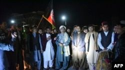 FILE - Youths and peace activists gather to celebrate a reduction in violence in Kandahar, Feb. 21, 2020. A partial truce had just taken effect.