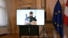 A screen displays a photo of a man arrested in connection with an attack plot that caused the cancellation of Vienna concerts by U.S. star Taylor Swift, at a press conference on Aug. 8, 2024, at the Foreign Ministry in Vienna, Austria.