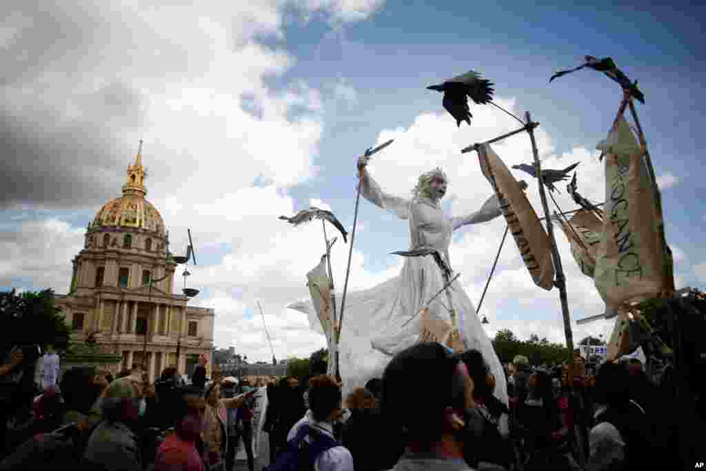A giant puppet is paraded during a demonstration of hospital workers, in Paris. Hospital workers and others are protesting in cities around the country to demand better pay and more investment in France&#39;s public hospital system.