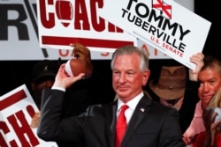 Republican Senator elect Tommy Tuberville throws footballs to supporters at his watch party at the Renaissance Hotel, Nov. 3, 2020, in Montgomery, Ala.