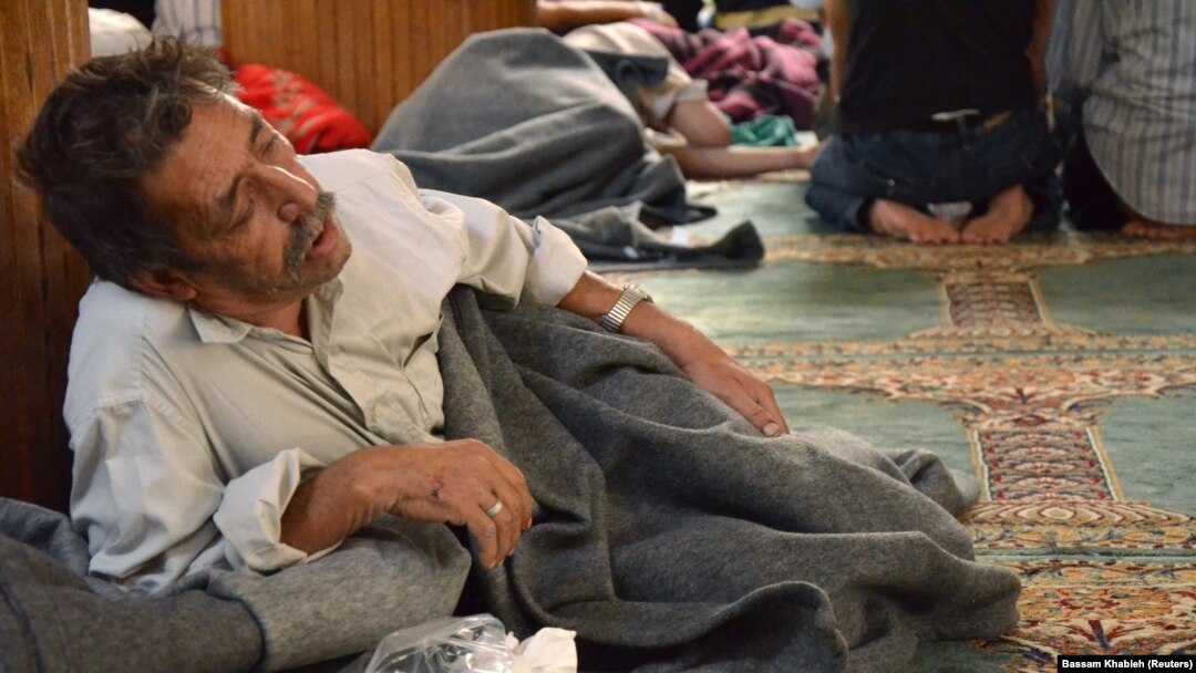 A survivor from what activists say is a gas attack rests inside a mosque in the Duma neighborhood of Damascus, Aug. 21, 2013. 