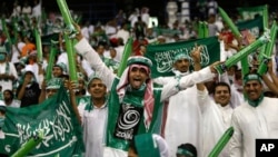 FILE - Saudi Arabian fans celebrate during a World Cup Asian qualifying playoff soccer match between Saudi Arabia and Bahrain at King Fahd Stadium in Riyadh, Saudi Arabia, Sept. 9, 2009.