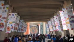 People arrive for the opening of the media center at the G20 Summit venue , in New Delhi, India, Friday, Sept. 8, 2023. 