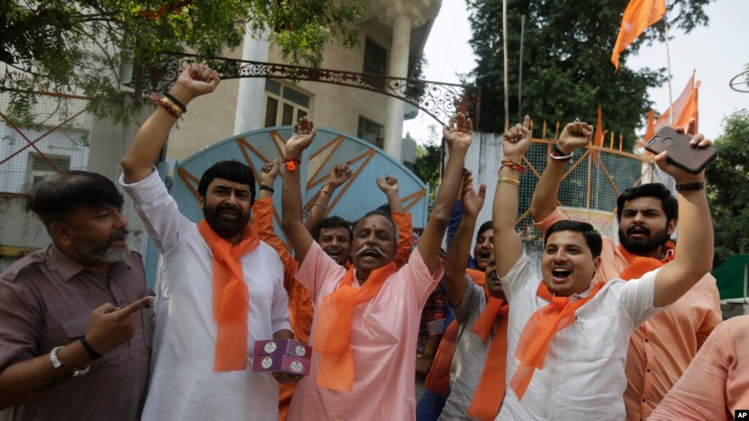 Supporters of Vishwa Hindu Parishad (VHP) or World Hindu council celebrate the Supreme Court's verdict, outside the VHP office in Ahmadabad, India, Nov. 9, 2019. 