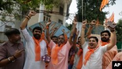 Supporters of Vishwa Hindu Parishad (VHP) or World Hindu council celebrate the Supreme Court's verdict, outside the VHP office in Ahmadabad, India, Nov. 9, 2019. 