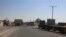 FILE -Trucks park in front of the gate on the Palestinian side of the Israeli Kerem Shalom cargo crossing in Rafah, southern Gaza Strip.