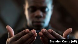 Paul Bronson prays during a Black Lives Matter ceremony at the First Baptist Church, a predominantly African-American congregation, in Macon, Georgia, July 11, 2016. (AP Photo/Branden Camp)