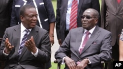 Ông Emmerson Mnangagwa, trái, trò chuyện với Tổng thống Zimbabwe Robert Mugabe sau lễ tuyên thệ tại Harare, 12/12/2014.