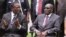 FILE: Emmerson Mnangagwa, left, Vice President of Zimbabwe chats with Zimbabwean President Robert Mugabe after the swearing in ceremony at State House in Harare, Dec, 12, 2014. 