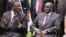 FILE: Emmerson Mnangagwa, left, Vice President of Zimbabwe chats with Zimbabwean President Robert Mugabe after the swearing in ceremony at State House in Harare, Dec, 12, 2014. 