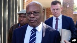 Papua New Guinea's sidelined Petroleum Minister Jimmy Maladina, center, leaves Waverley Local Court House in Sydney, July 11, 2024. 