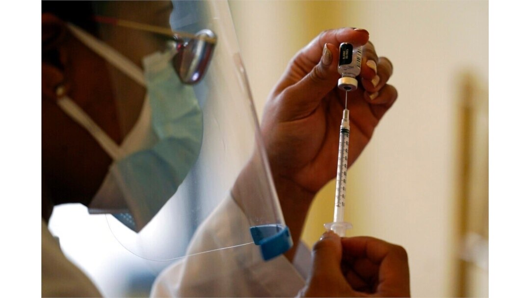FILE - A Walgreens pharmacist prepares a syringe with COVID-19 vaccine in Coral Gables, Fla., Jan. 12, 2021.