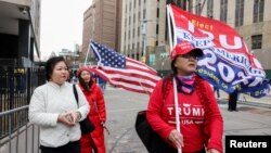 Supporters of former President Donald Trump arrive at the Manhattan Criminal Courthouse after Trump's indictment by a Manhattan grand jury following a probe into hush money paid to porn star Stormy Daniels, in New York City, April 3, 2023.