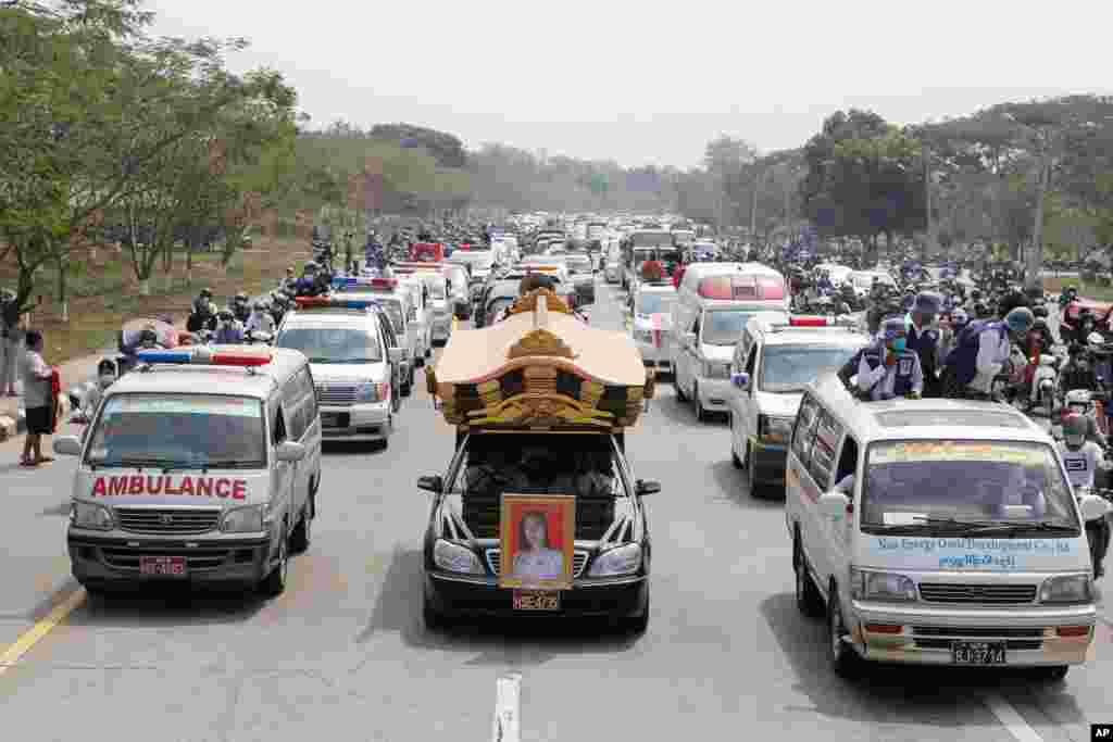 A hearse containing casket of Mya Thwet Thwet Khine travels to the cemetery in Naypyitaw, Myanmar. The young protester died after she was shot in the head when police tried to disperse a crowd during a protest against the Feb. 1 military coup.